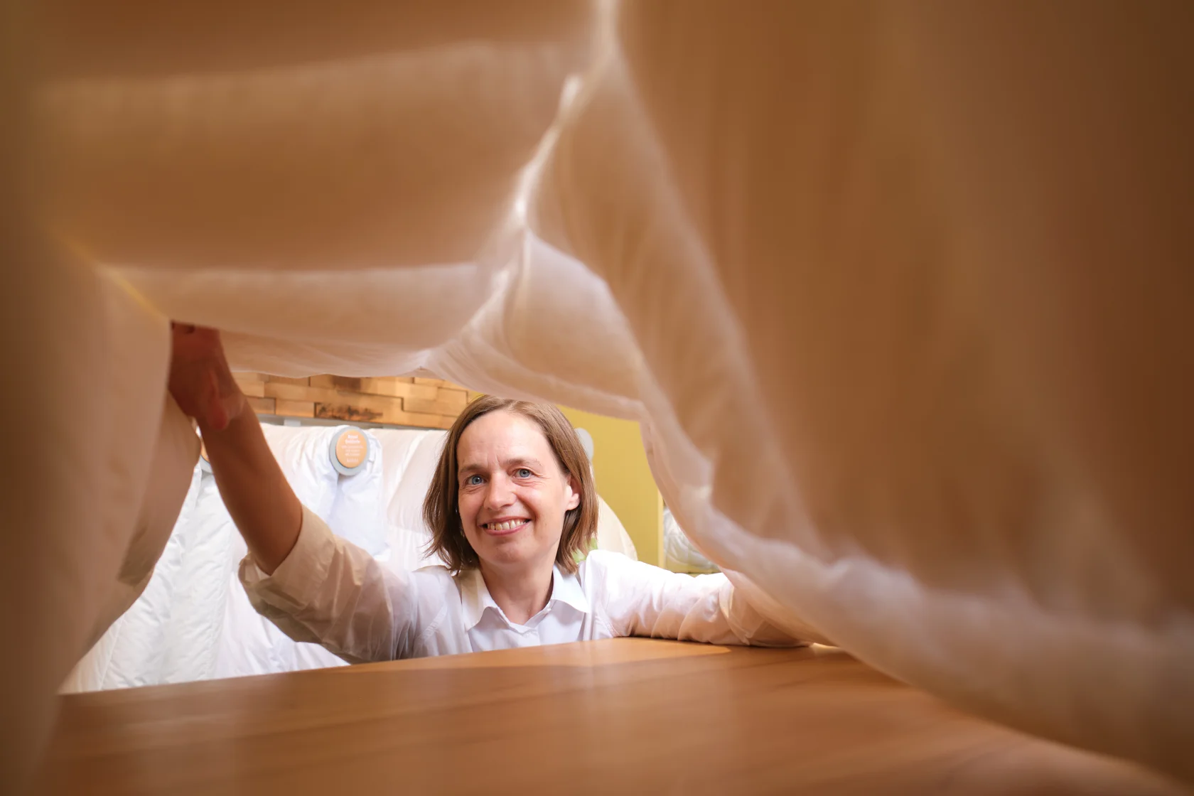 Frau Vollrath unter einer Daunendecke